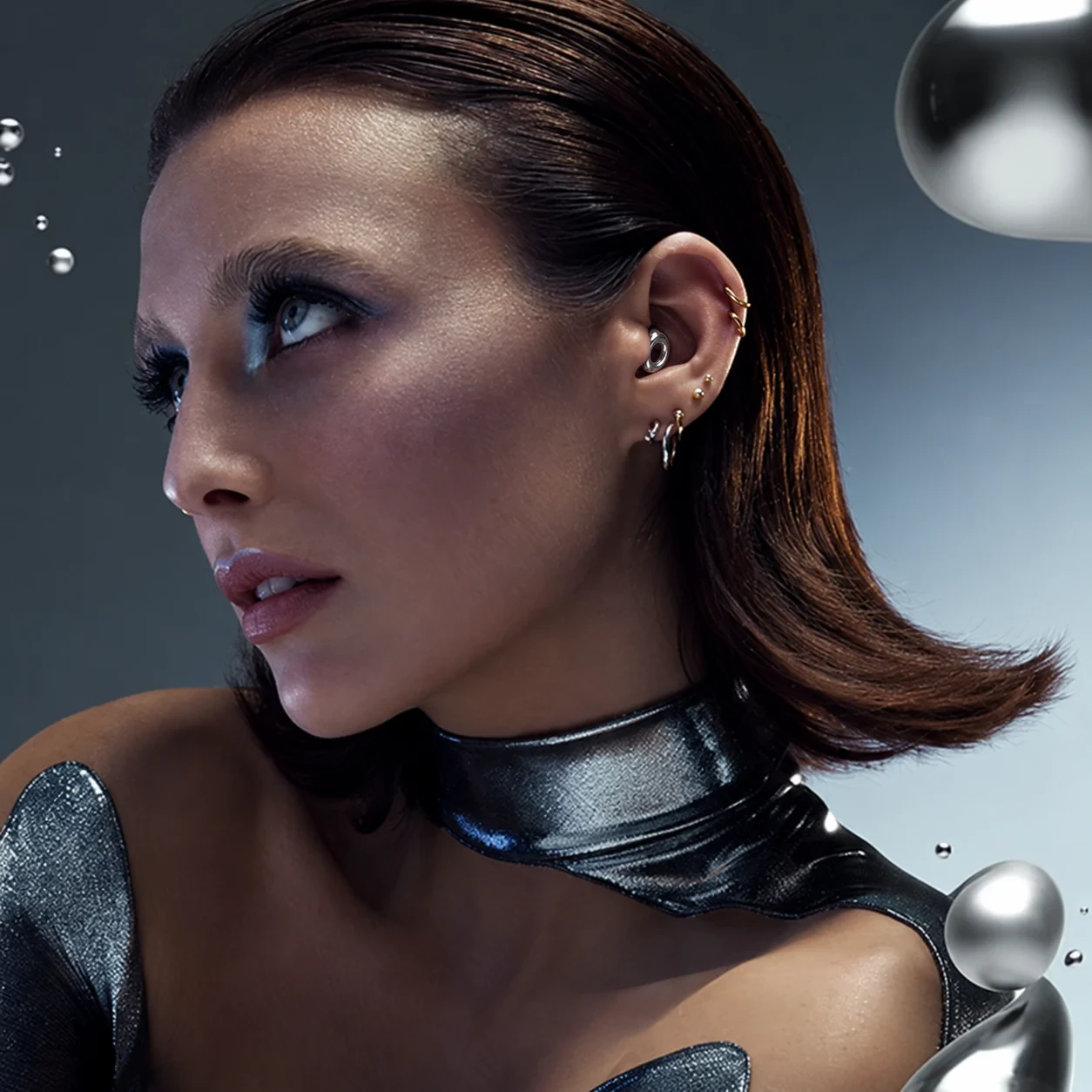 Woman wearing silver Loop earplugs
