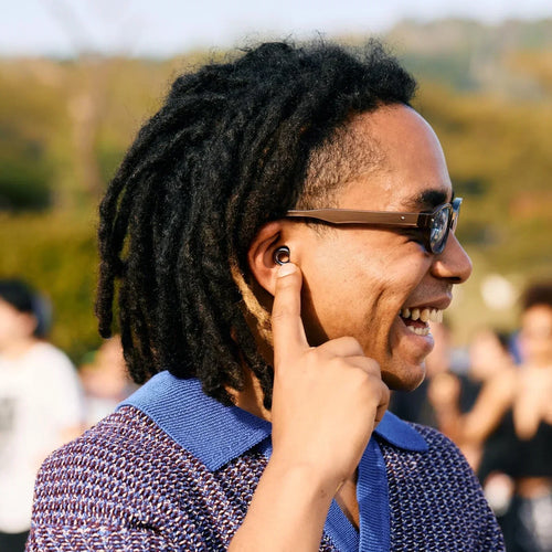 Person wearing an earplug while enjoying time outdoors